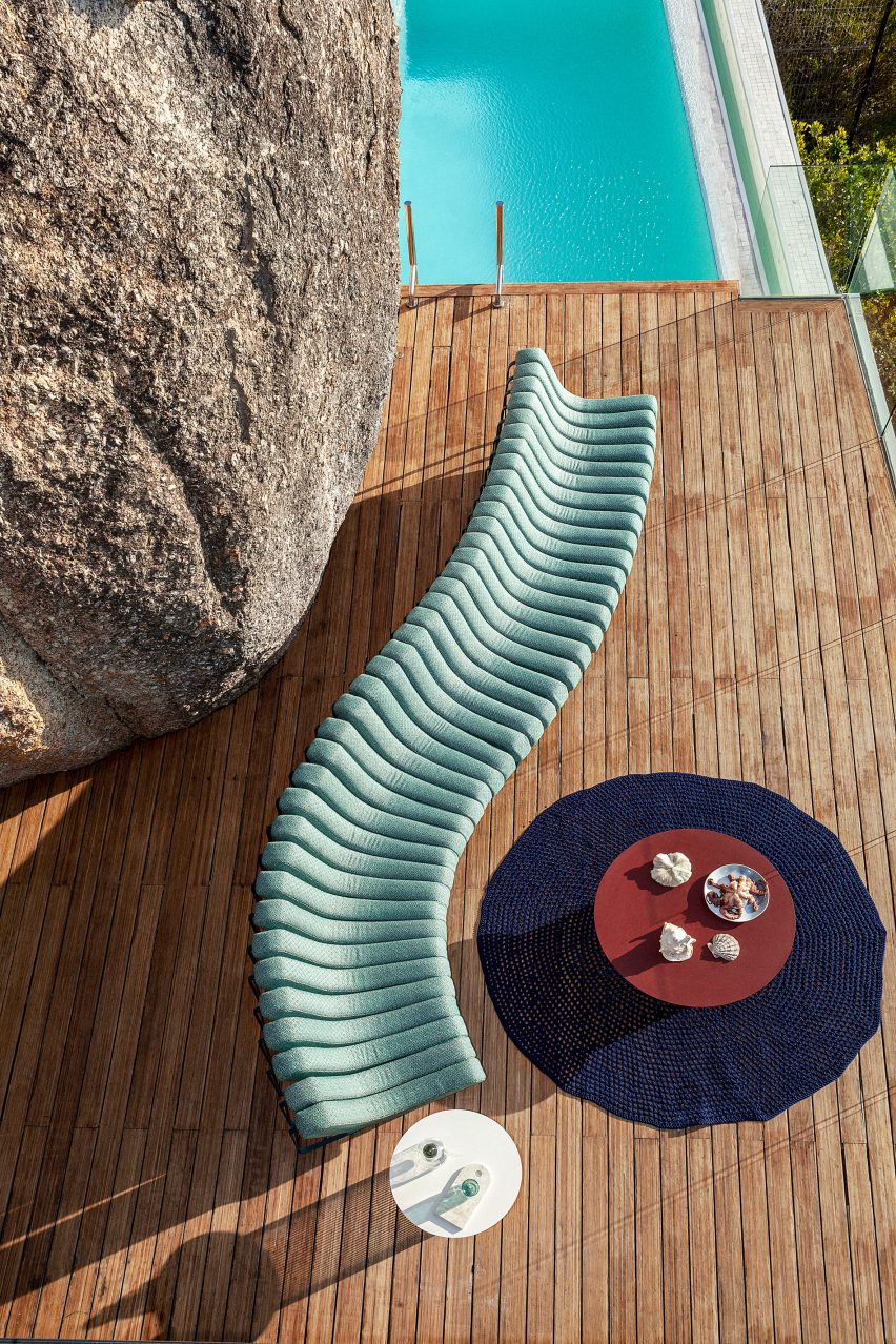 Songololo sofa in aqua blue on a wooden deck