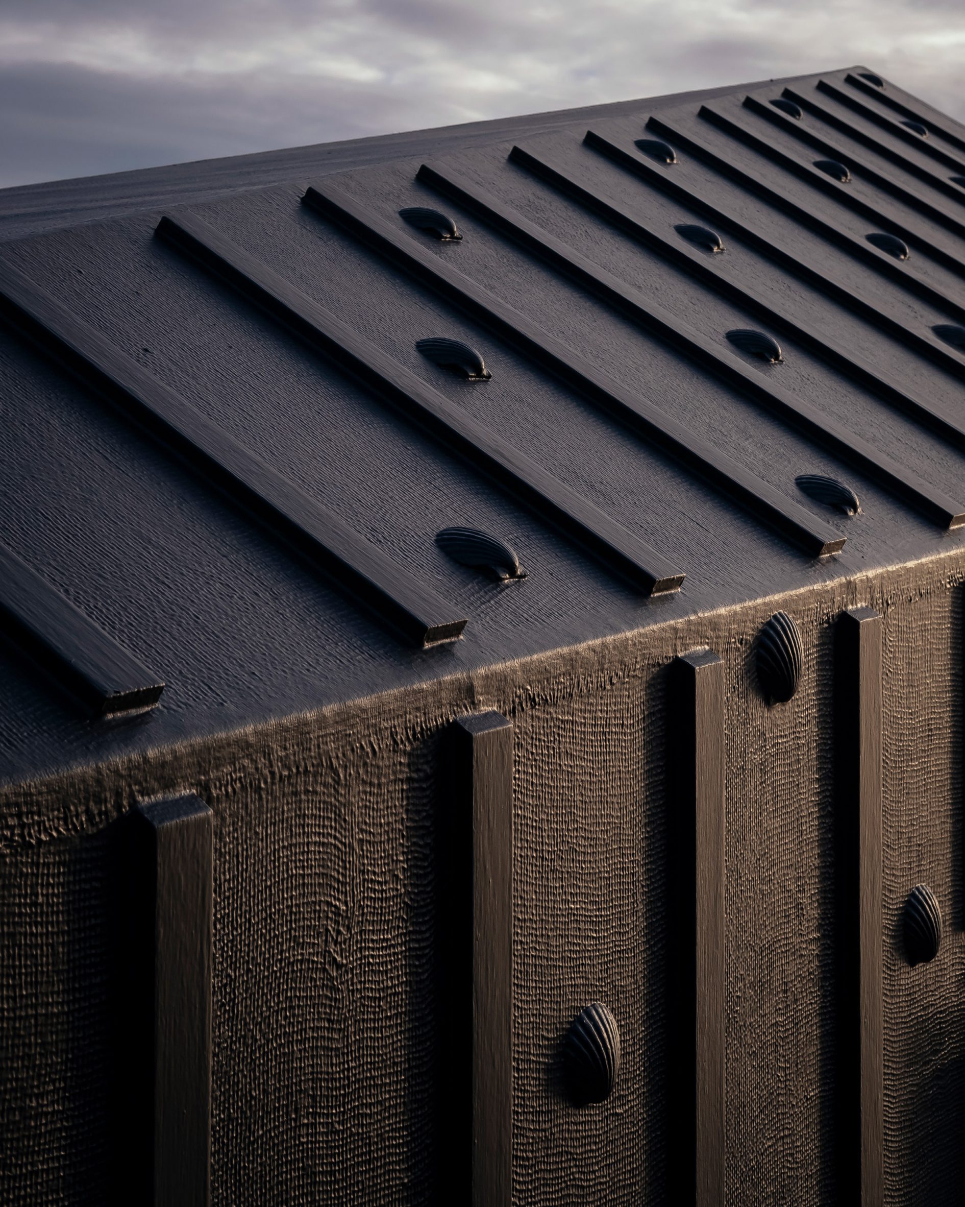 Black-rubber facade adorned with shells