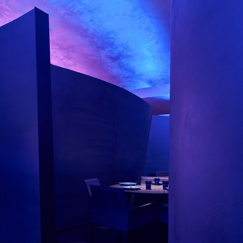 Curved partitions inside blue restaurant
