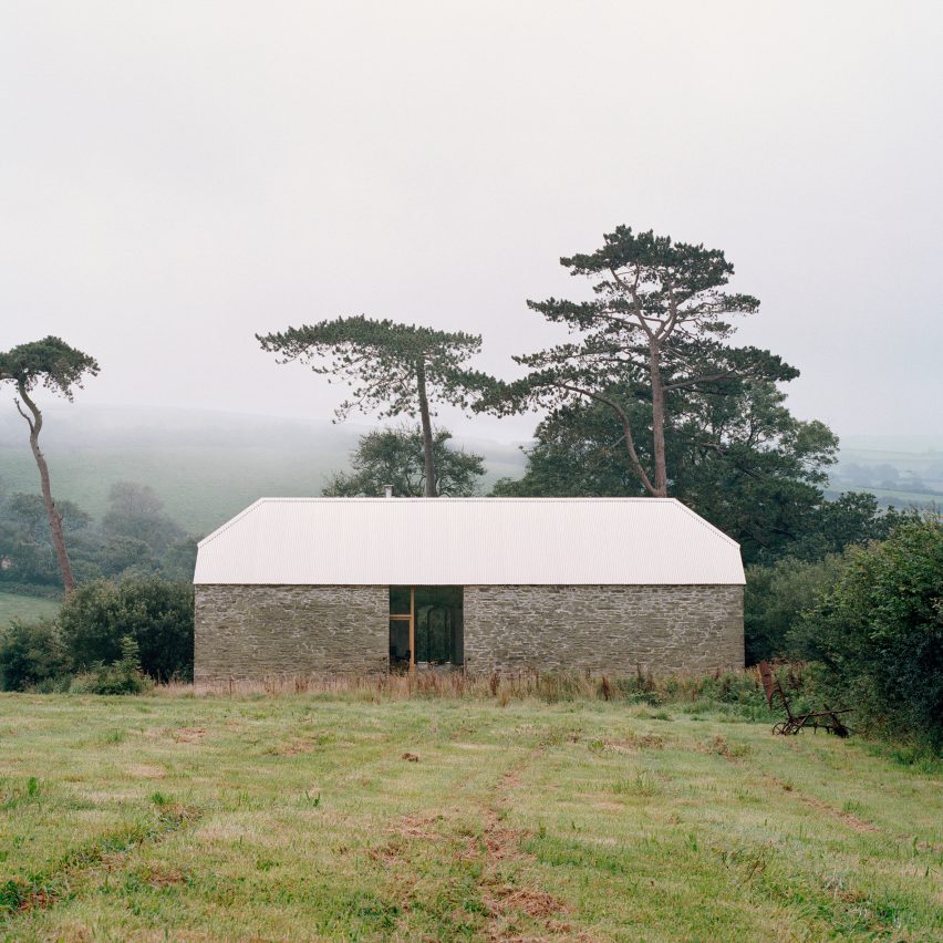 Stone barn with aluminium roof by TYPE on a grassy hill