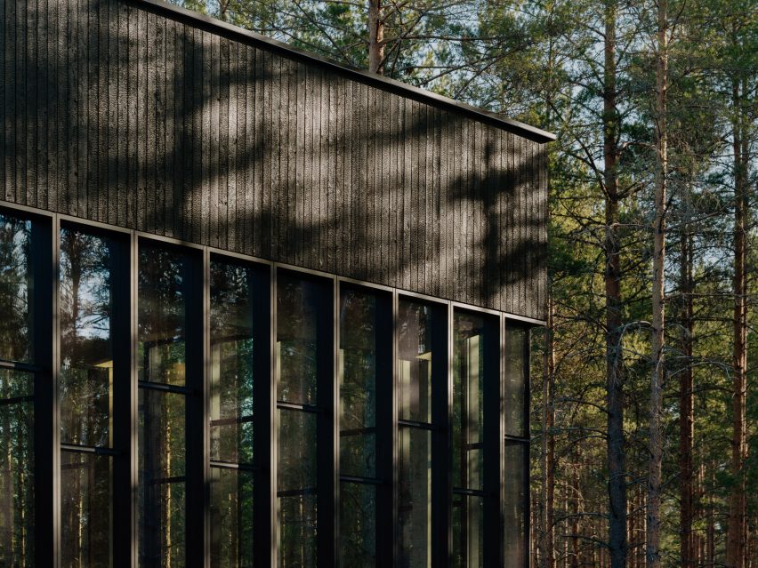 Black wooden cladding of The Plus furniture factory by BIG
