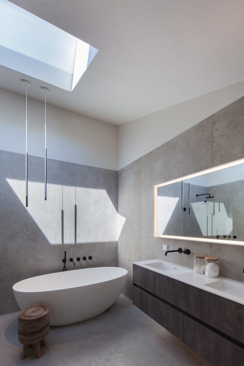 The bathroom at the timber-clad home has a contemporary look