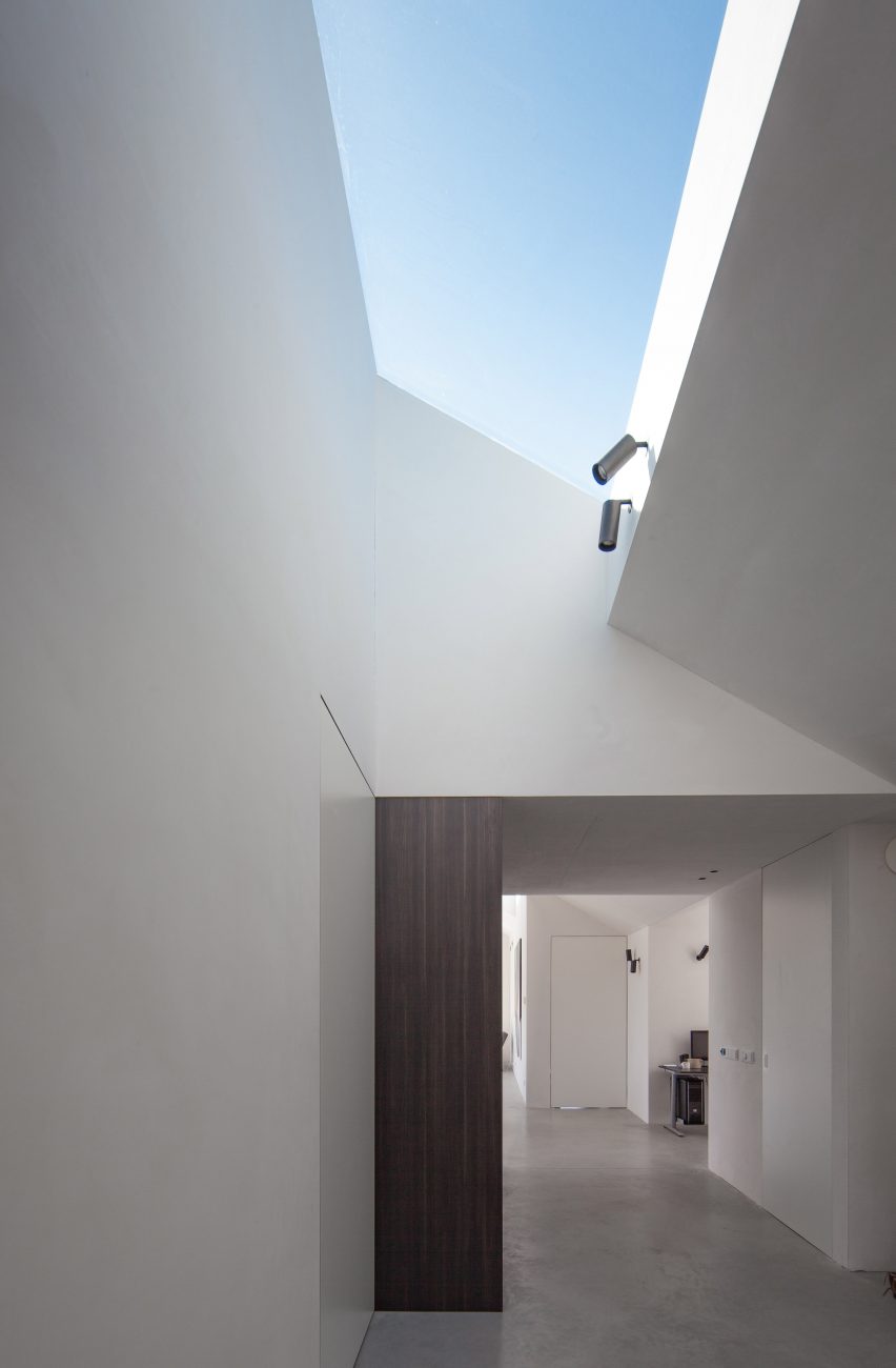 White-walled corridor lit by skylight 