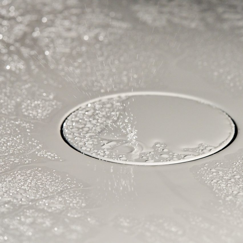 Closeup shot of shiny white bathroom surface with water droplets