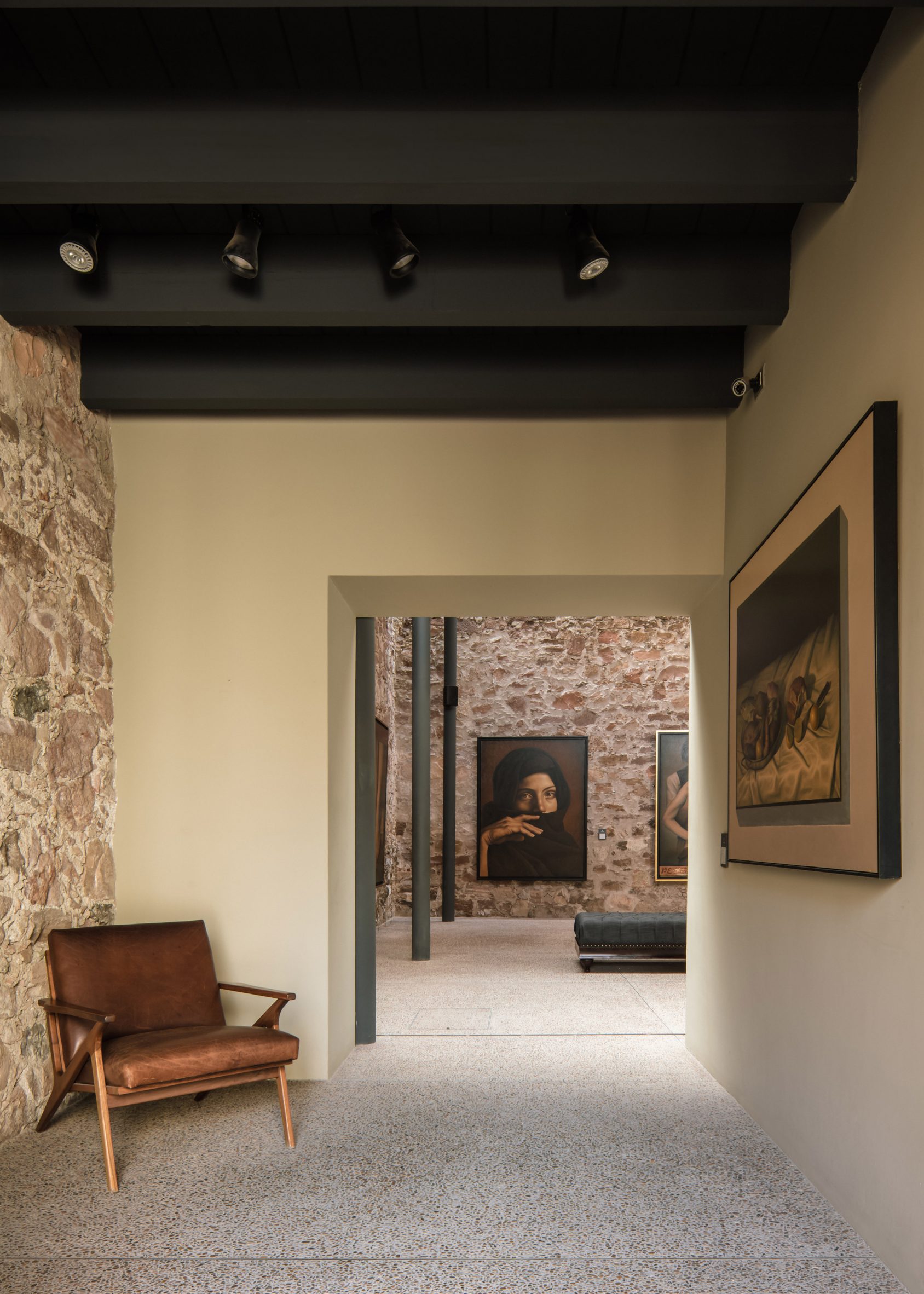 Exposed stone and leather chair in gallery
