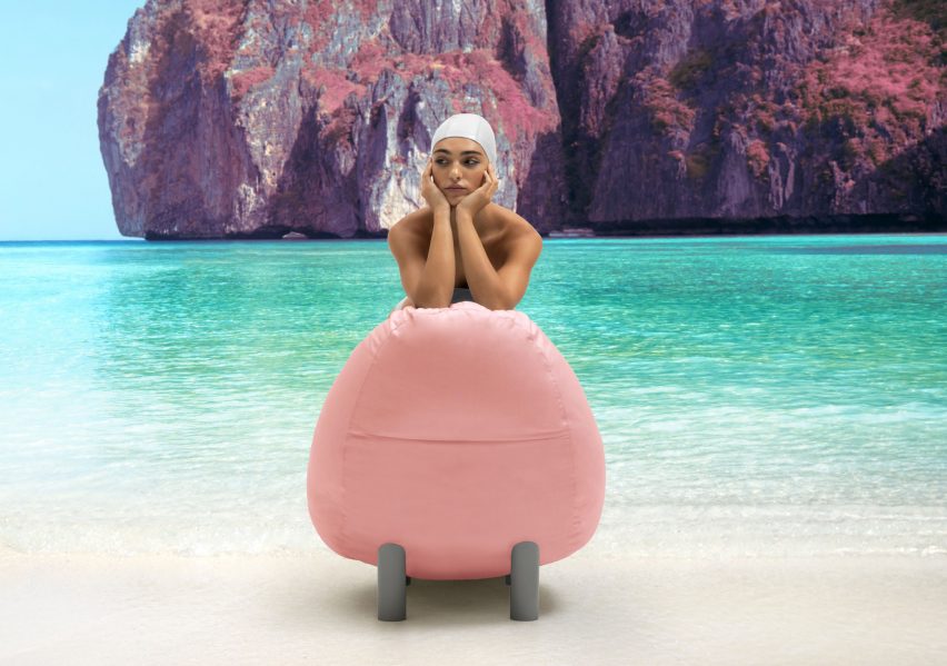 Pink seat with black legs in use on beach