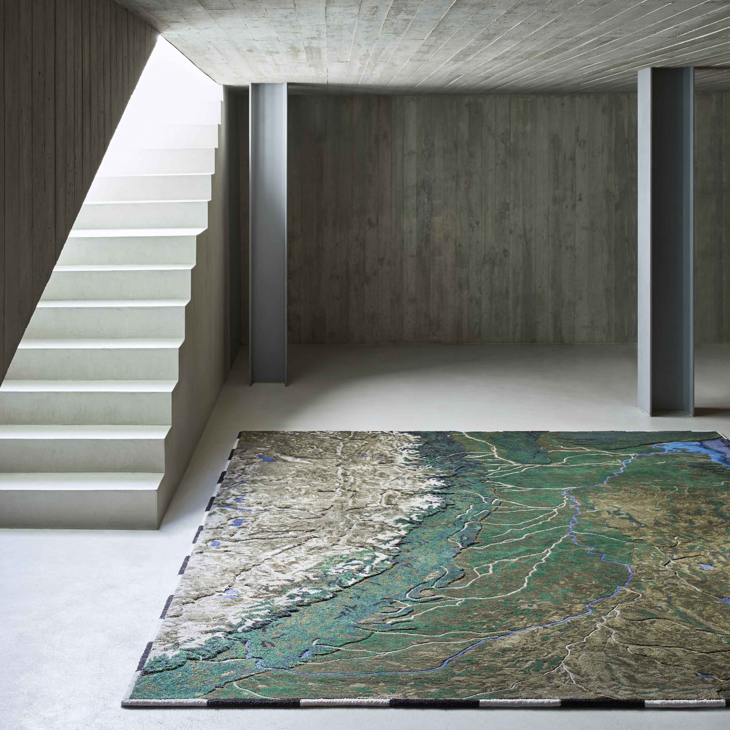 Rivers Plastic Rugs by Álvaro Catalán de Ocón for Gan in a Concrete Room with Stairs on the Left