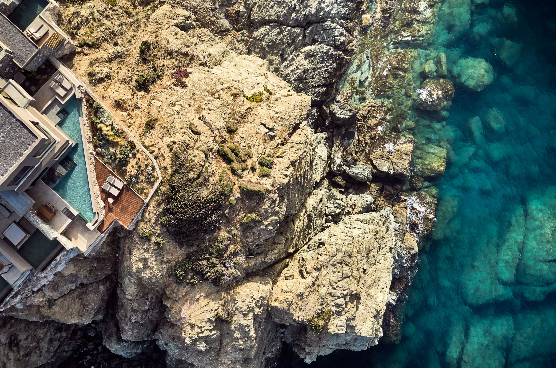 Overhead view of pool and deck in Arco Suites hotel on cliffside in Crete 