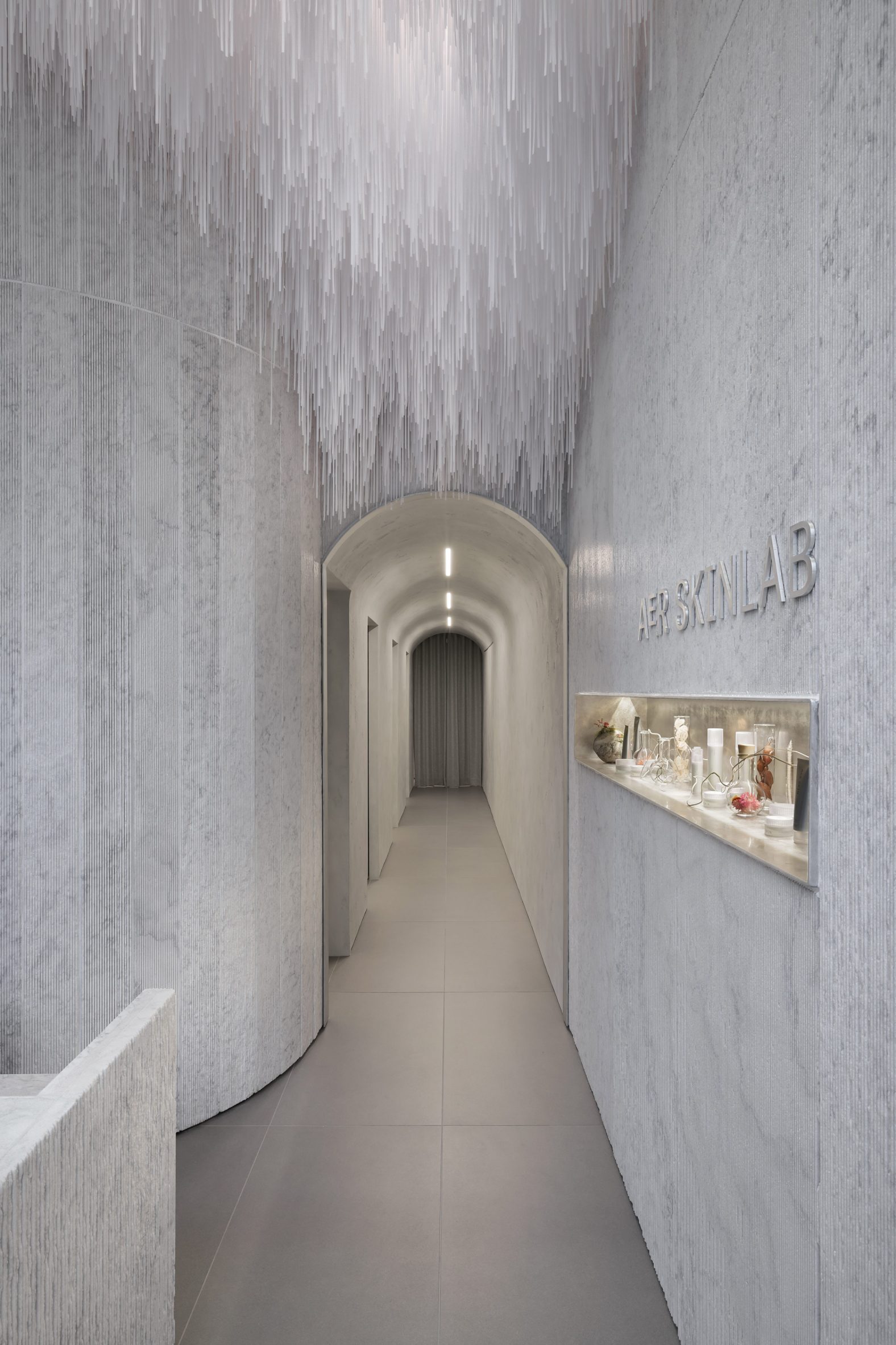 Marble-lined hallway of Vancouver skincare clinic designed by Leckie Studio