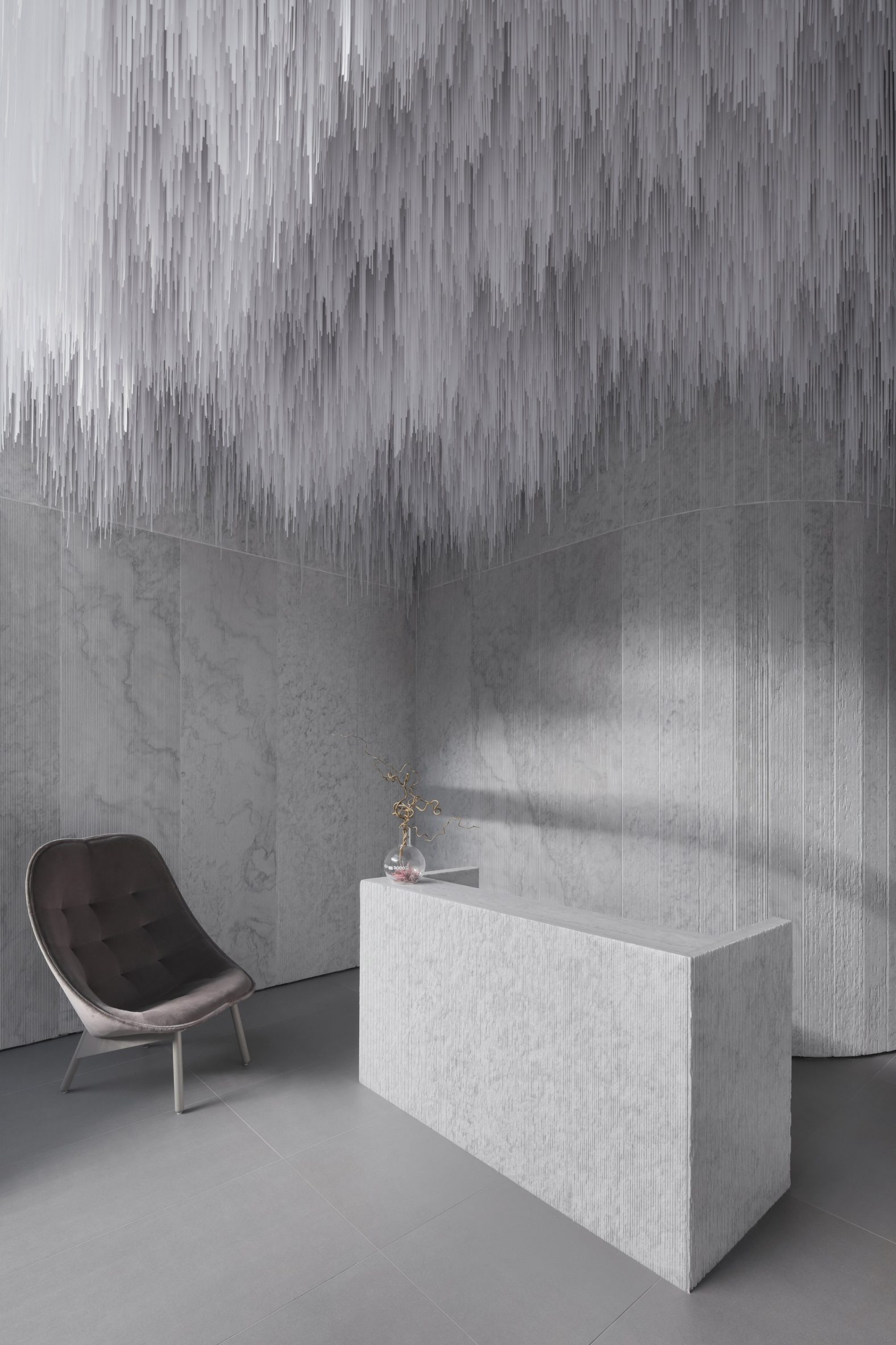 Vancouver Leather Clinic Reception with Marble Walls and Stalactite-like Ceiling Installation