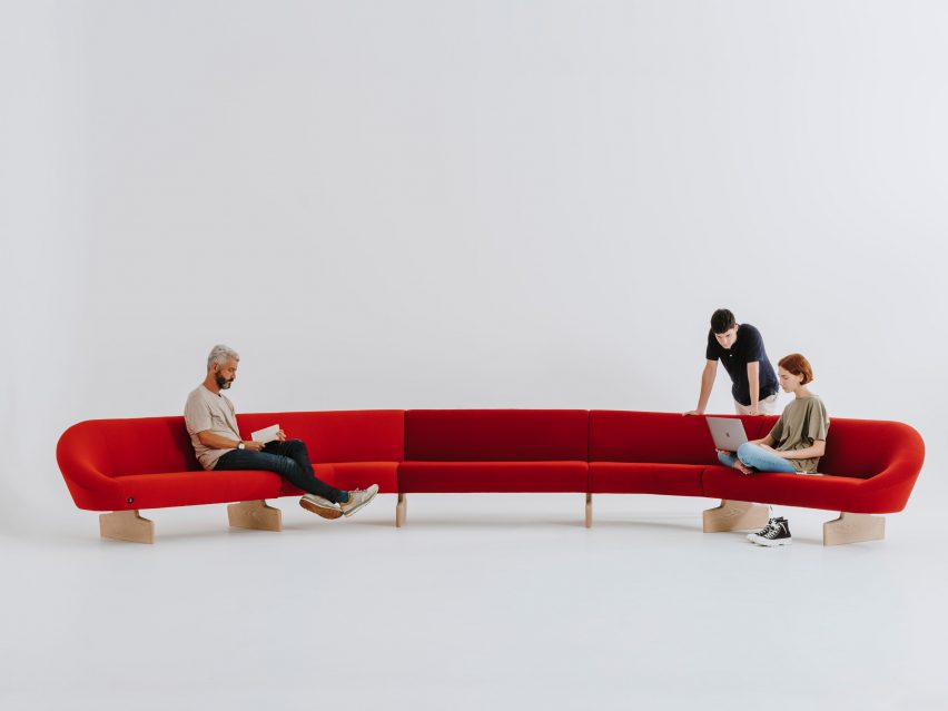 Large curving red Giro Soft sofa with ash wood sled legs