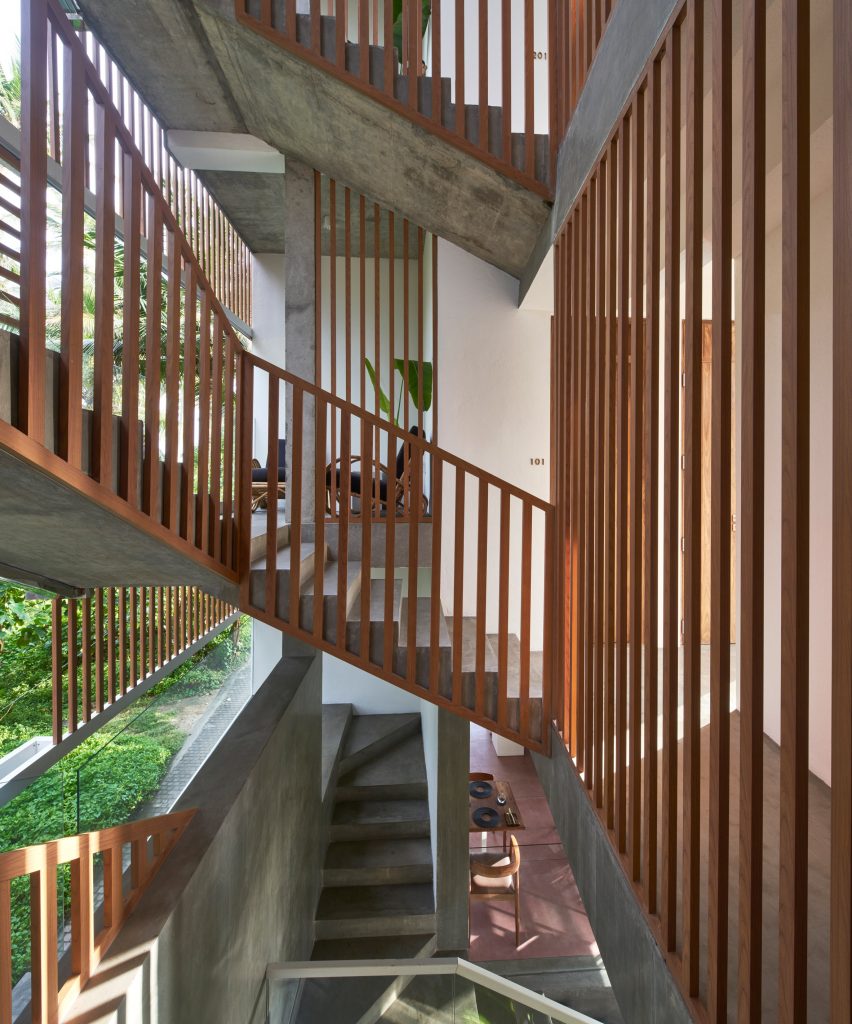 Staircase with wooden panels and bannisters partly open to the elements