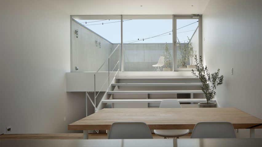 View from kitchen to elevated terrace in Aquarium House in Kanagawa by Nao Iwanari