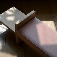 End of light ply bench with shadows and pink upholstry
