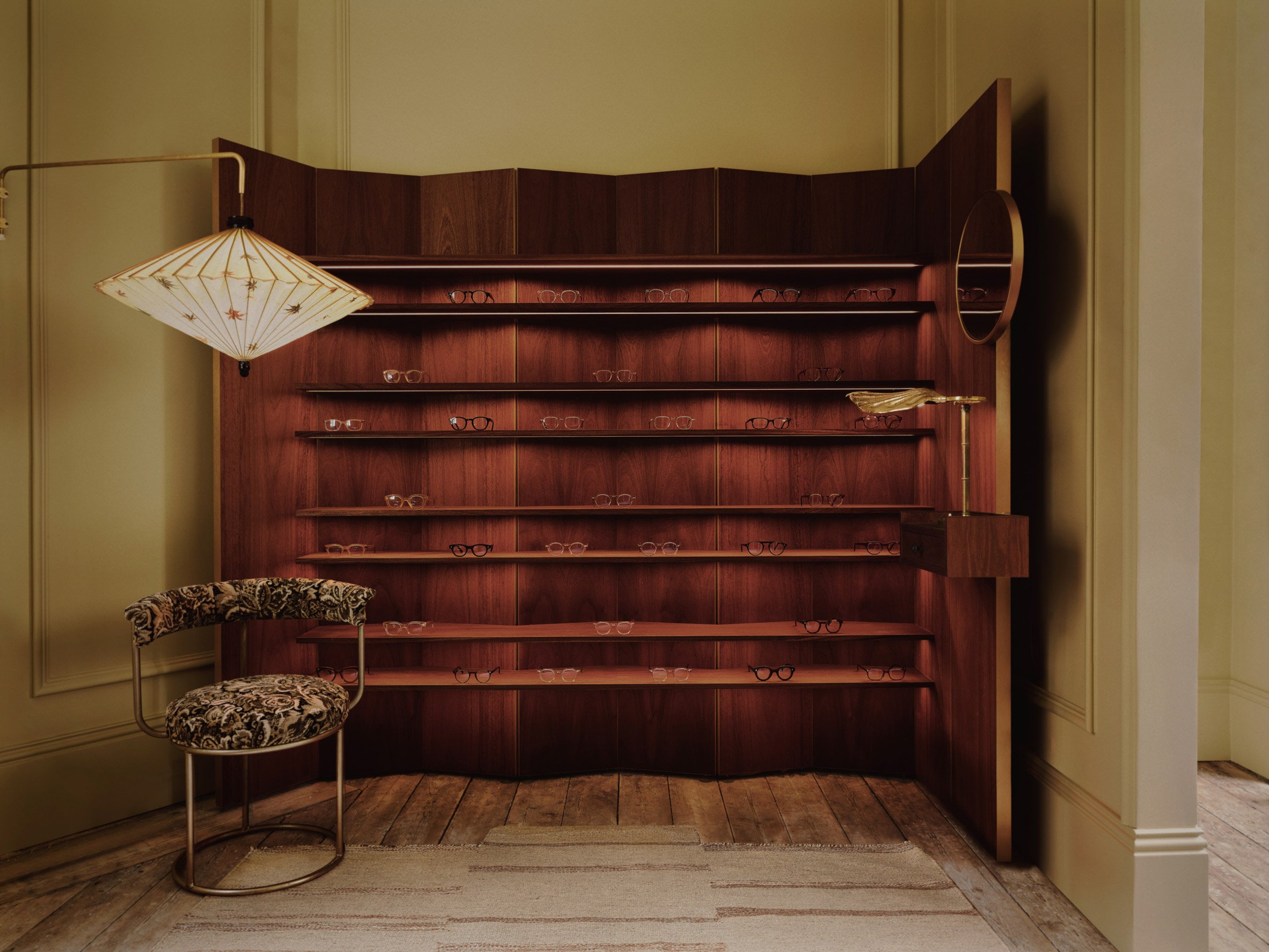Mahogany display stand in eyewear shop designed by Child Studio
