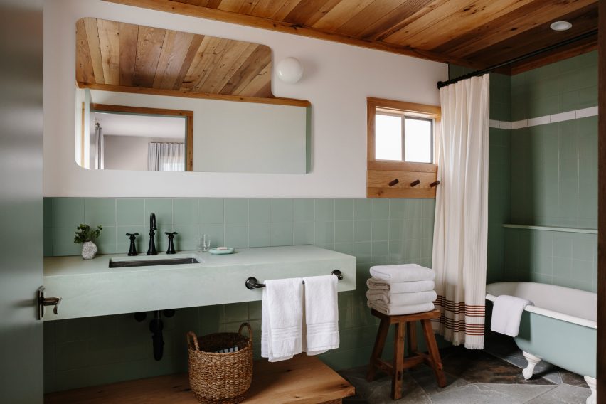 Guest room bathroom with green tiling