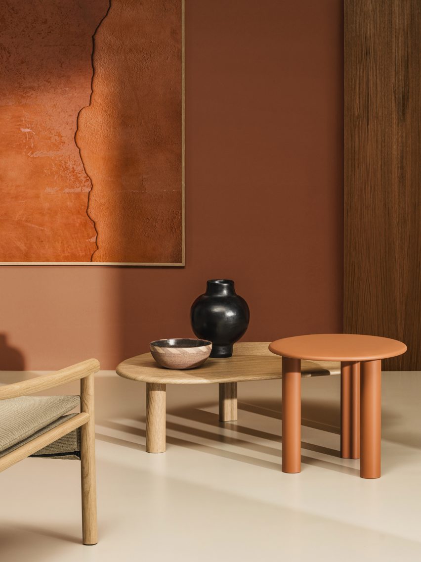 Orange circular and natural wood asymmetrical Ghia tables by Arper in a natural-toned living space
