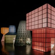 Hermès creates "monumental" water tower structures that glow like lanterns