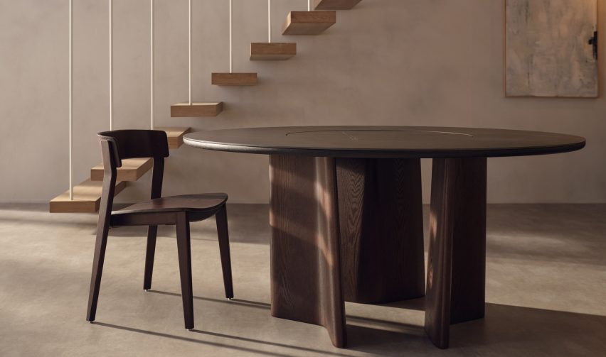 A rounded top Issho table is pictured in an interior setting