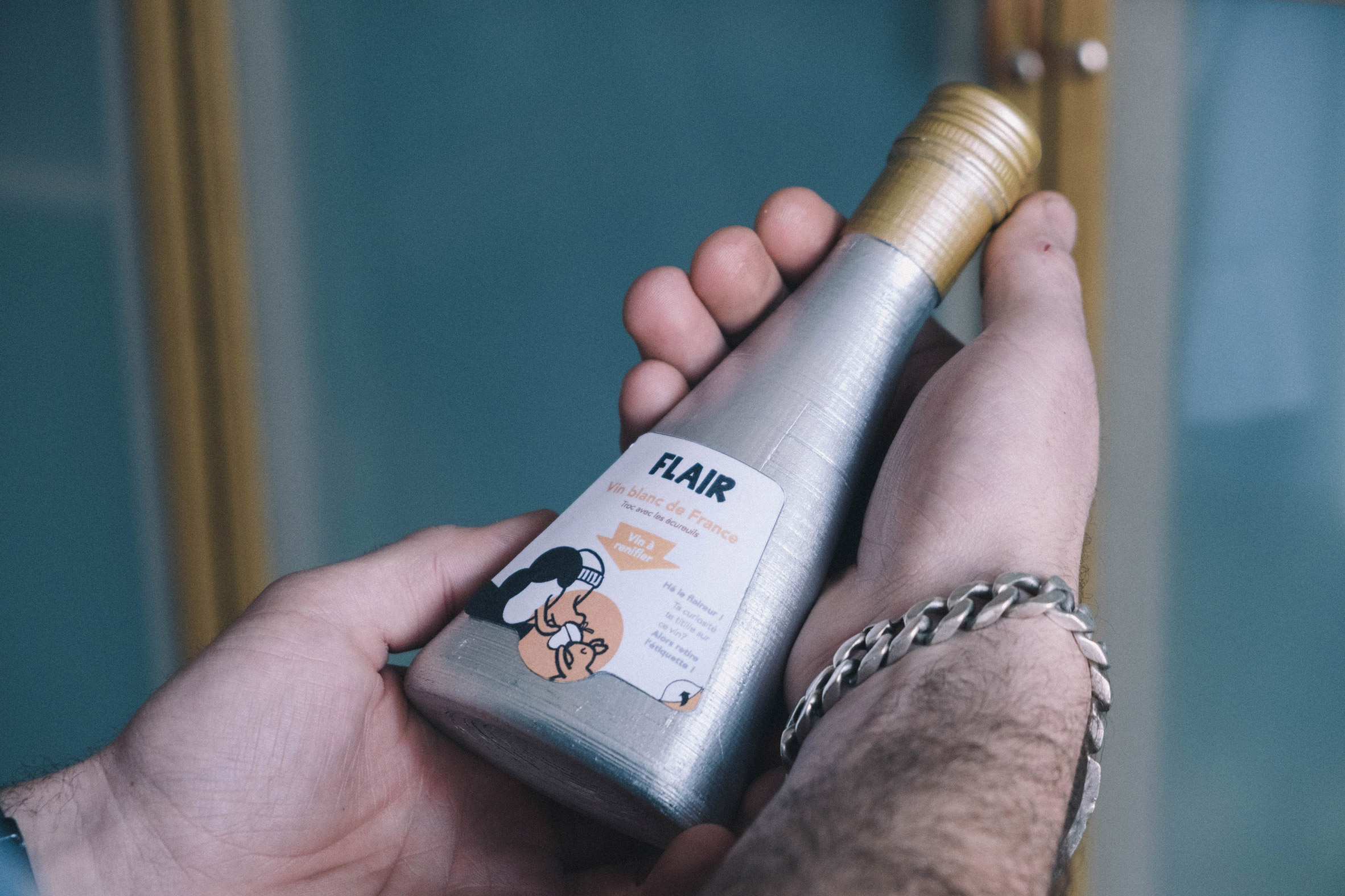 Person holding Flair wine bottle