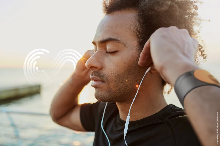 A runner listening to earphones