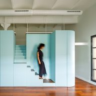 NeuronaLab reorganises Barcelona loft with blue stair storage unit