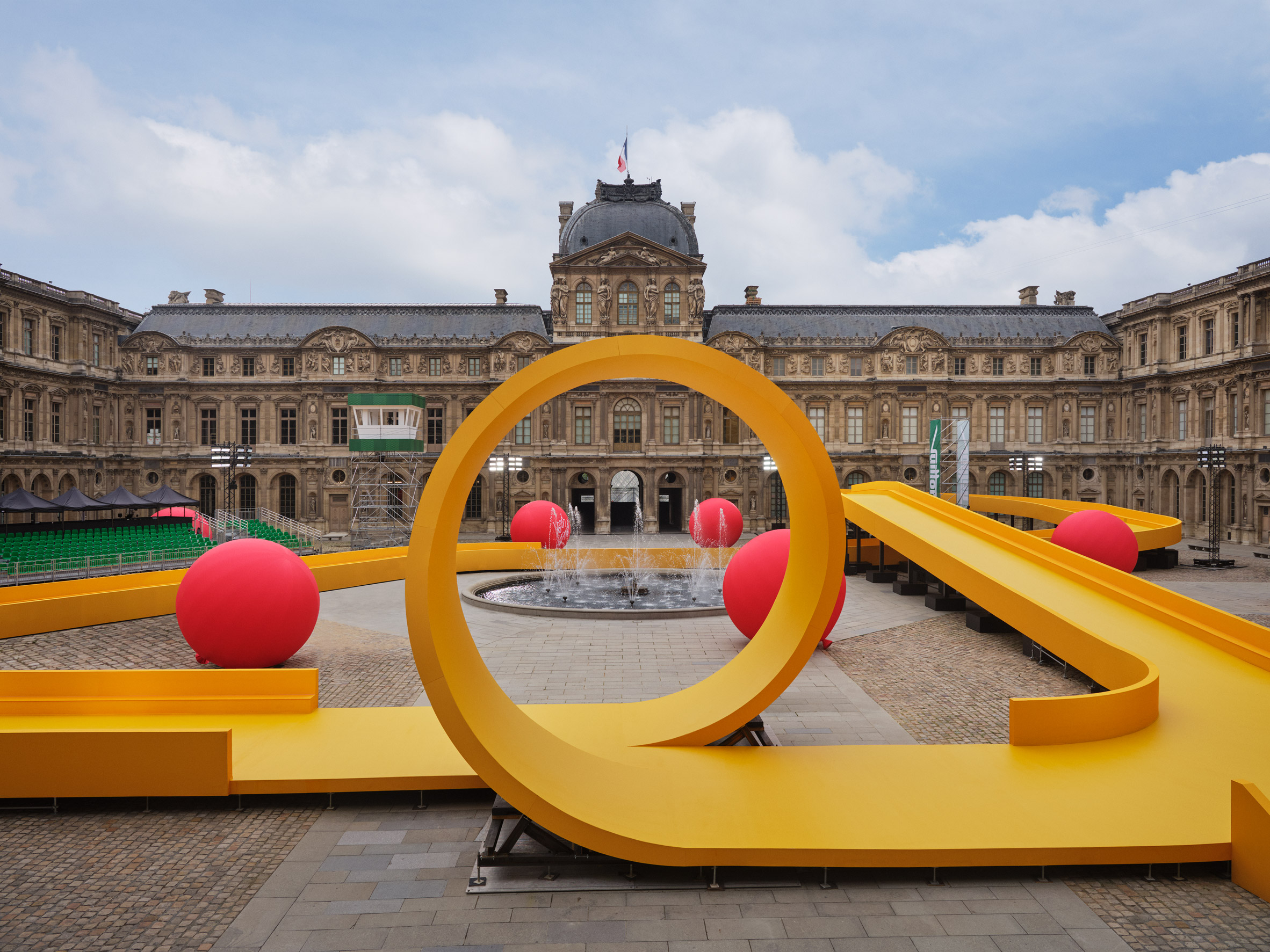 Louis Vuitton inserts a yellow racetrack at the Louvre for Spring Summer  2023 show