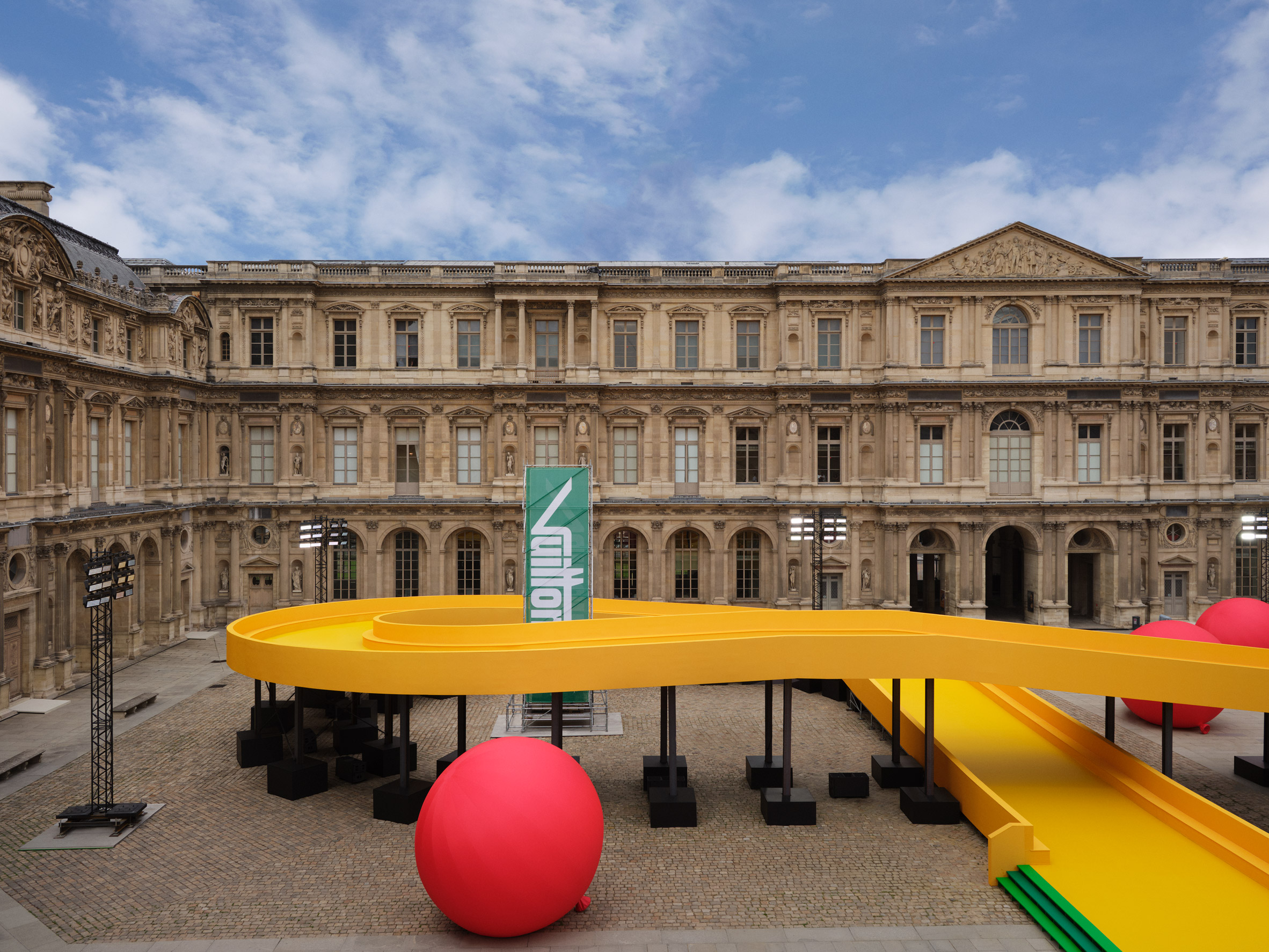 Louis Vuitton inserts a yellow racetrack at the Louvre for Spring
