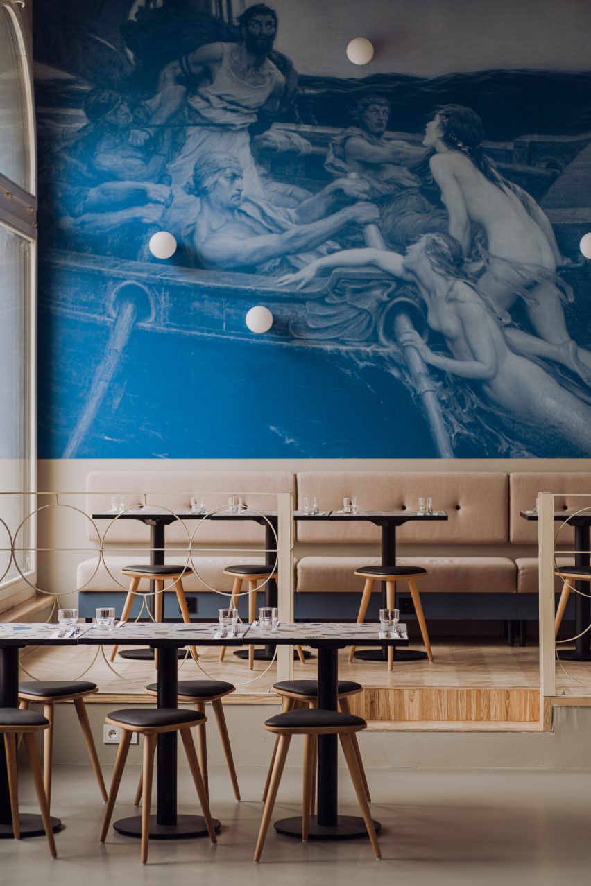 Neutral-toned seating area with blue wallpaper in Syrena Irena pierogi restaurant