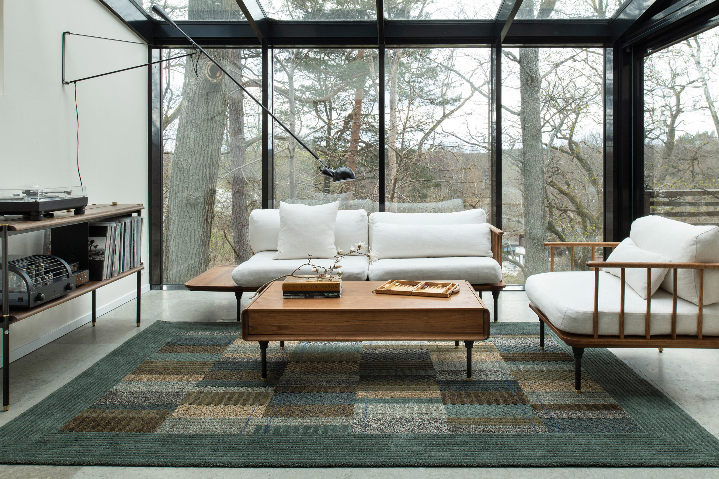 A living room with a geometric rug