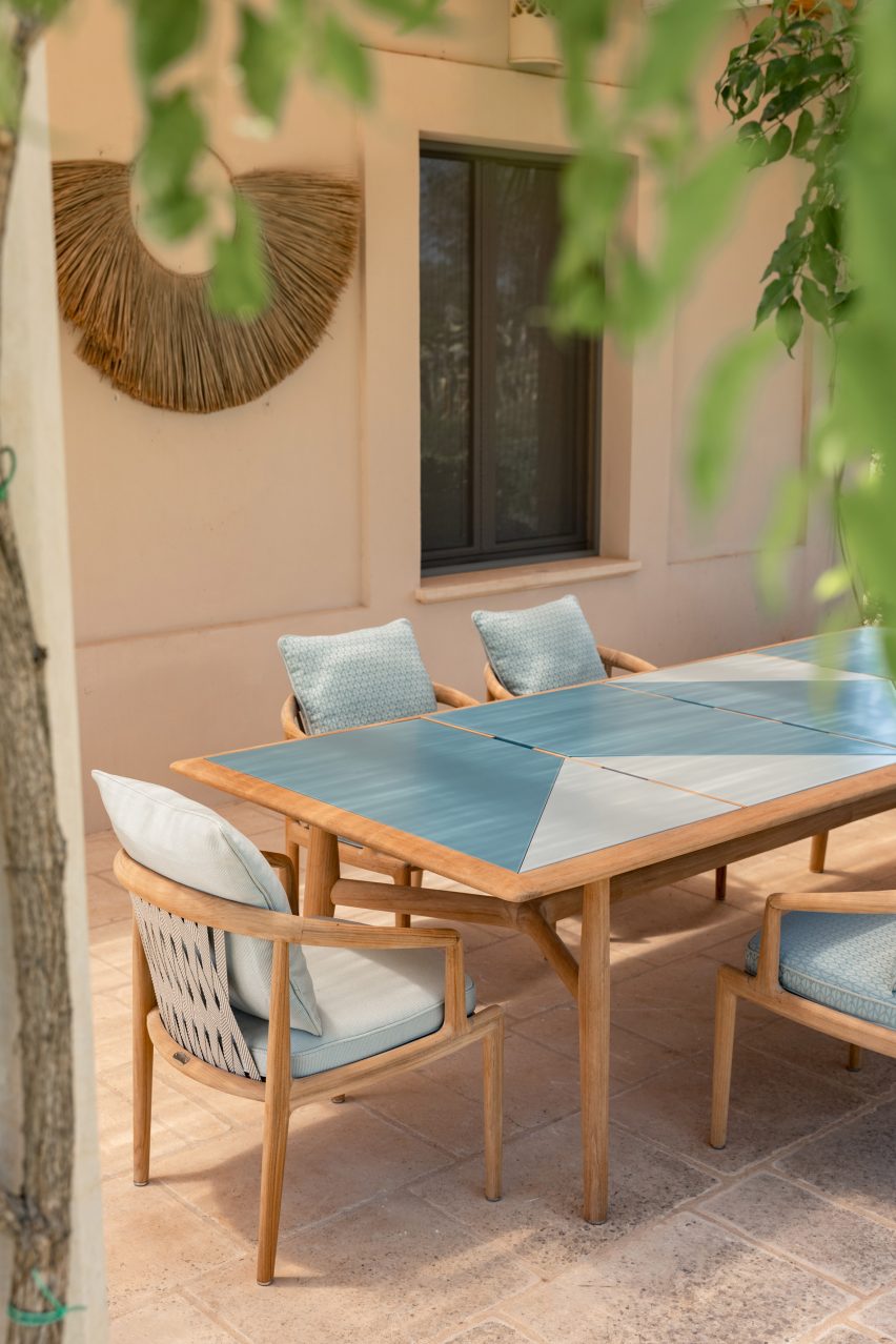 A wooden table with a blue top outside