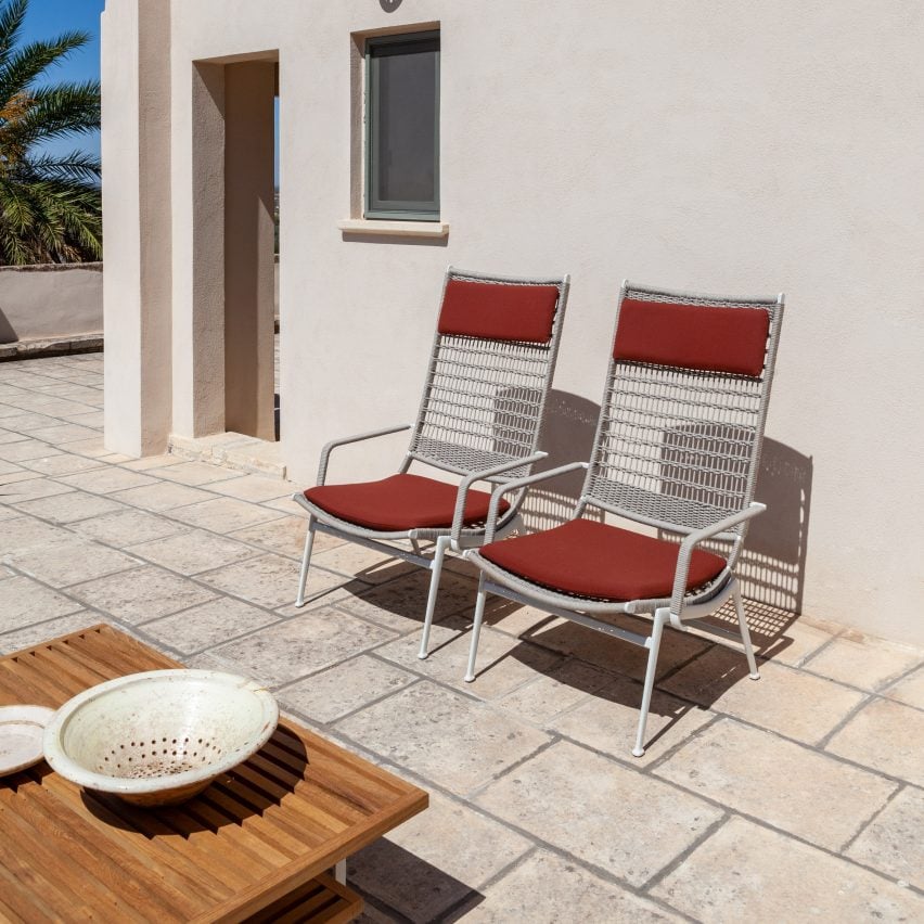 Two Solaria armchairs by Poltrona Frau on a tiled outdoor patio