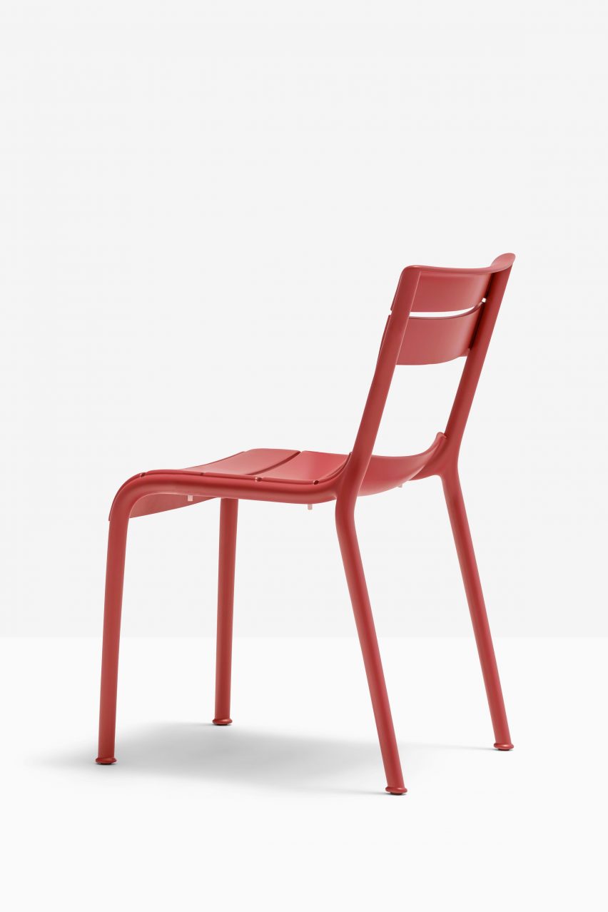 Souvenir chair in red, rear quarter view on white backdrop