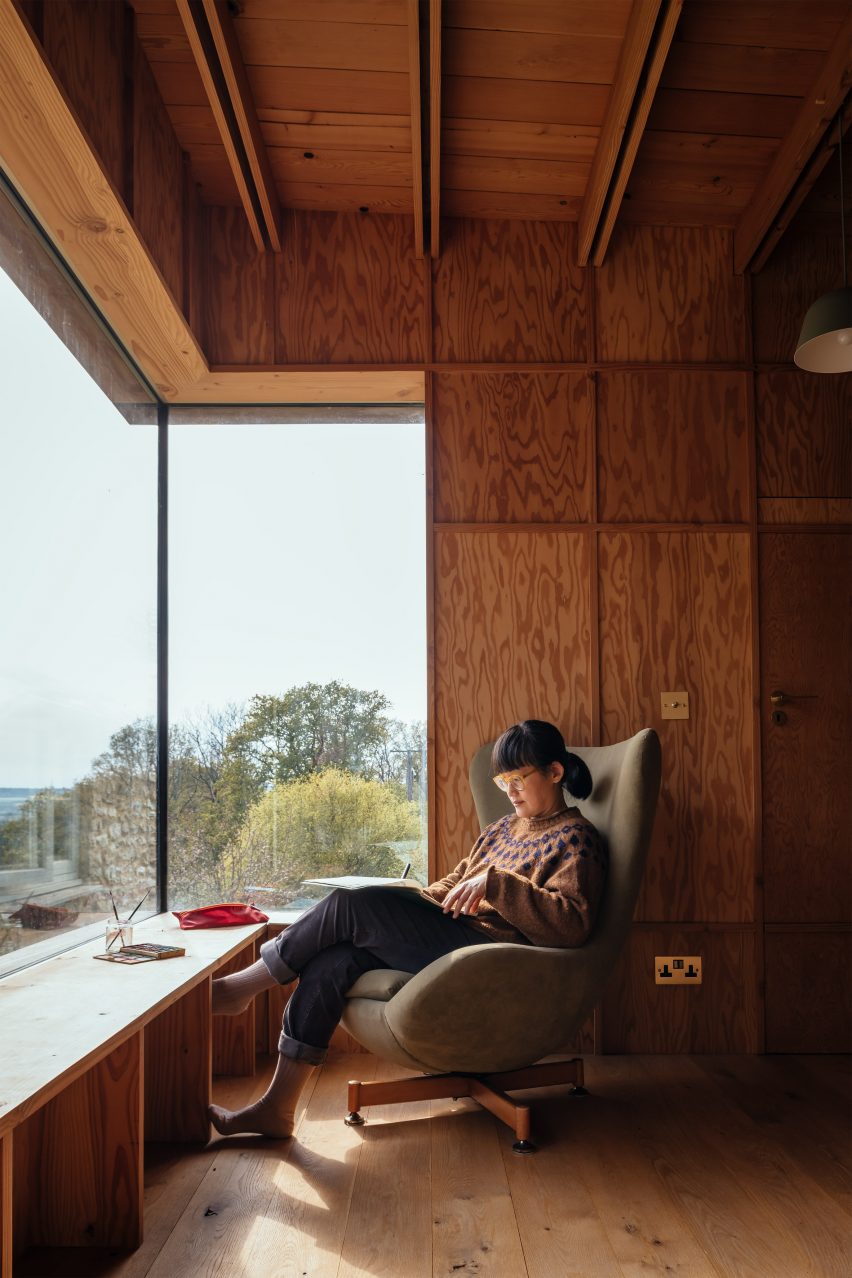 Wood-lined living space with window seat