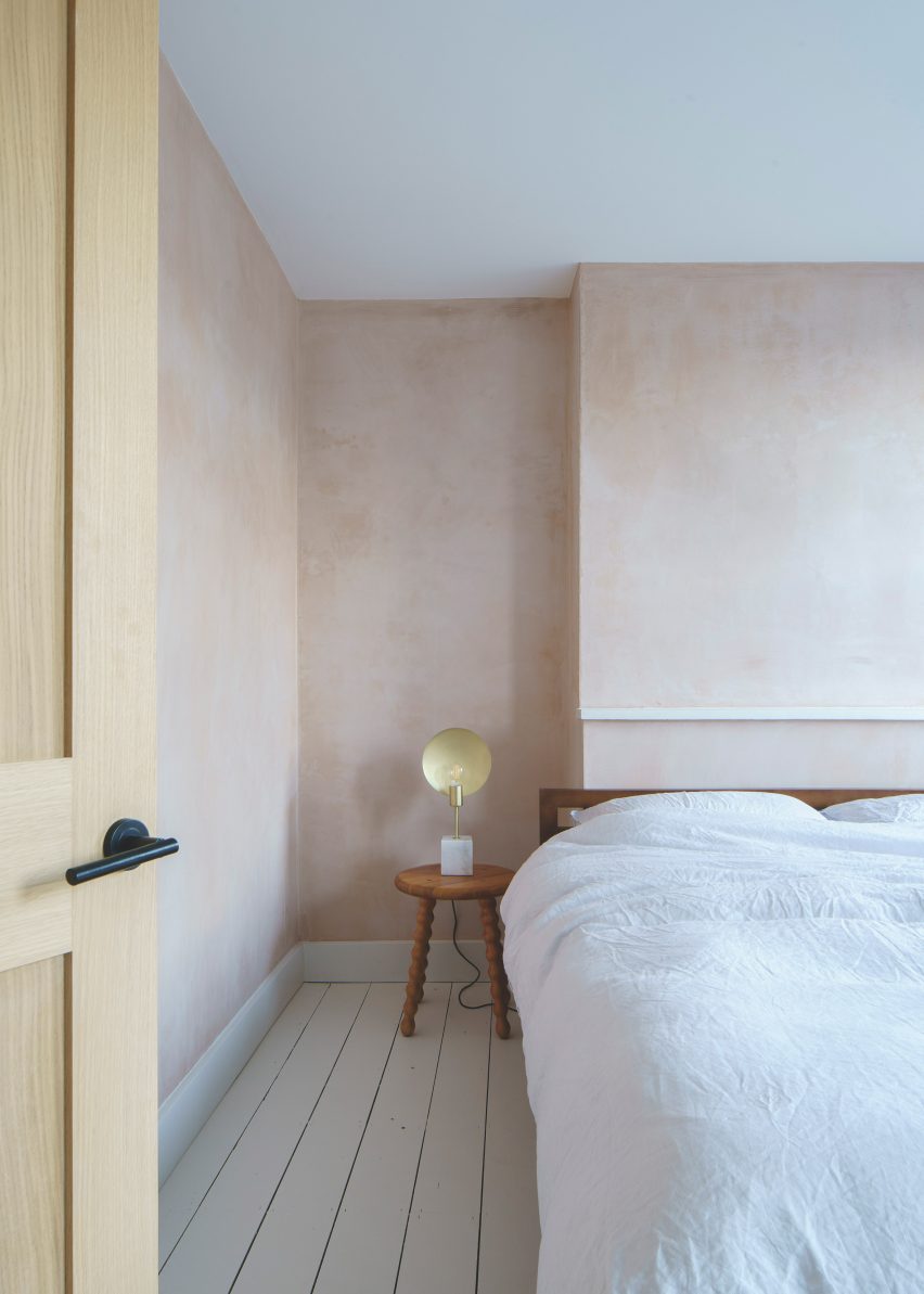 Bedroom with pink-hued plaster walls