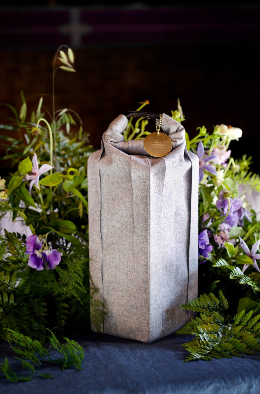 Woolen burial urn designed by Claesson Koivisto Rune surrounded by a floral arrangement