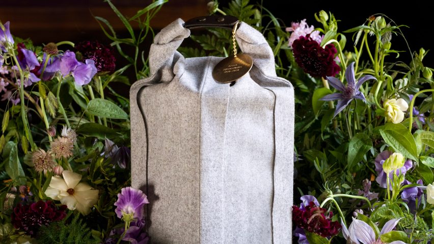 Woolen Ocke burial urn designed by Claesson Koivisto Rune for Systrarna Ocklind surrounded by a floral arrangement