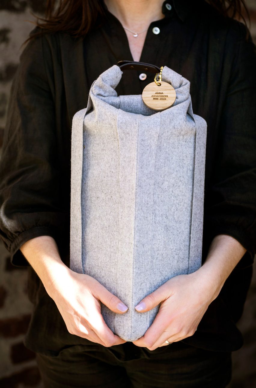 Woman holding a woolen Ocke burial urn by Systrarna Ocklind