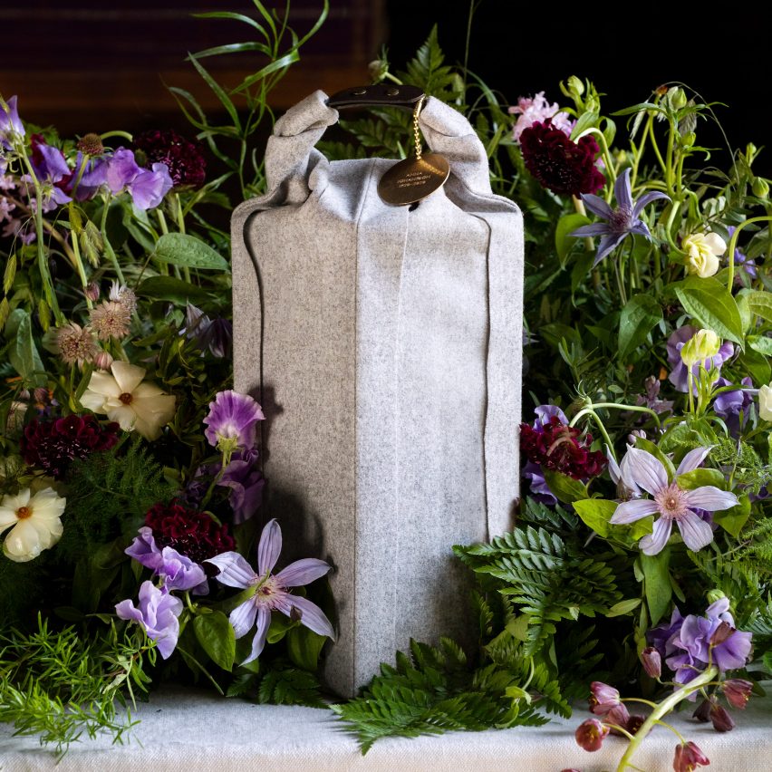 Woolen Ocke burial urn designed by Claesson Koivisto Rune for Systrarna Ocklind surrounded by a floral arrangement