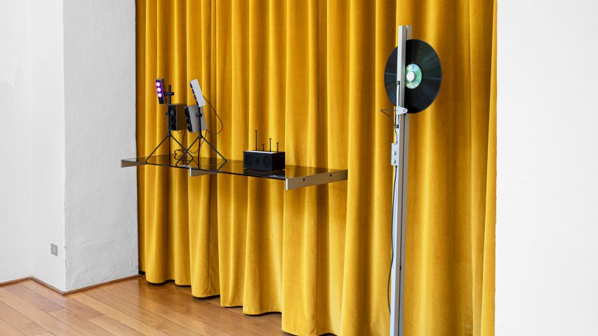 Sound machines on display in front of a yellow curtain