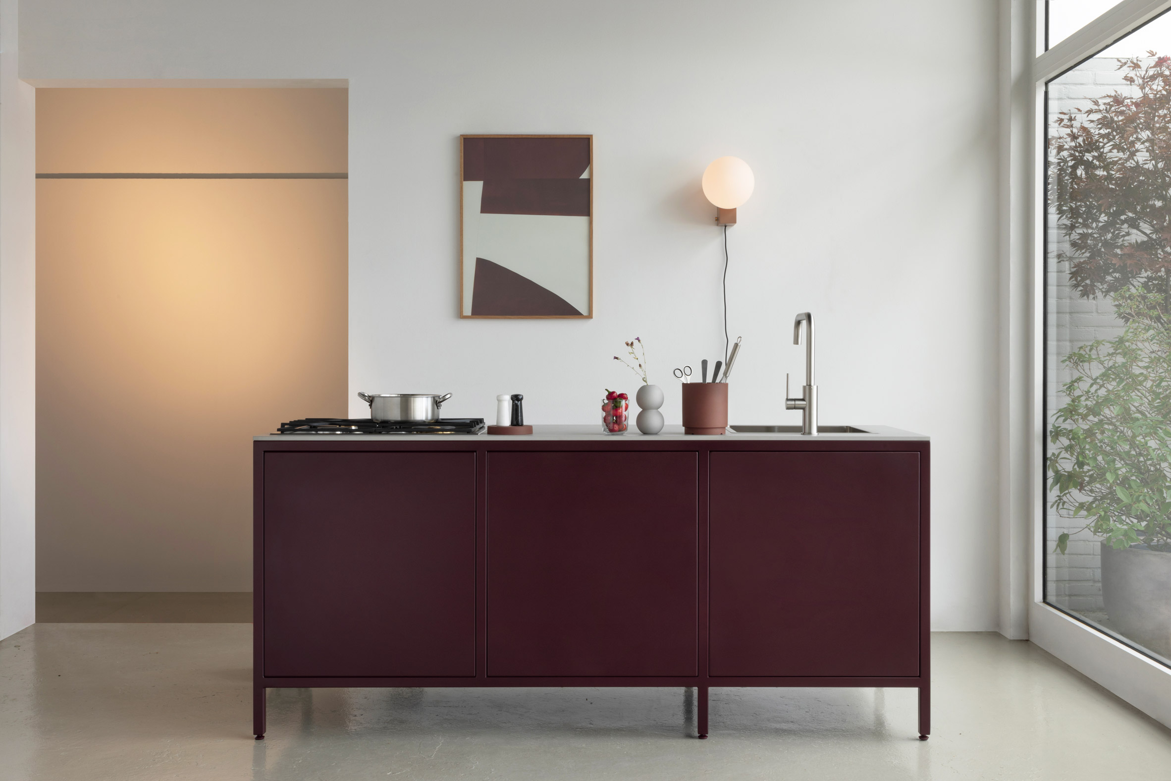 Burgundy kitchen unit in domestic space