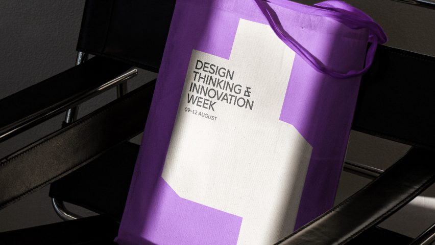 A photograph of a purple tote bag on a chair with the Design Thinking and Innovation Week logo