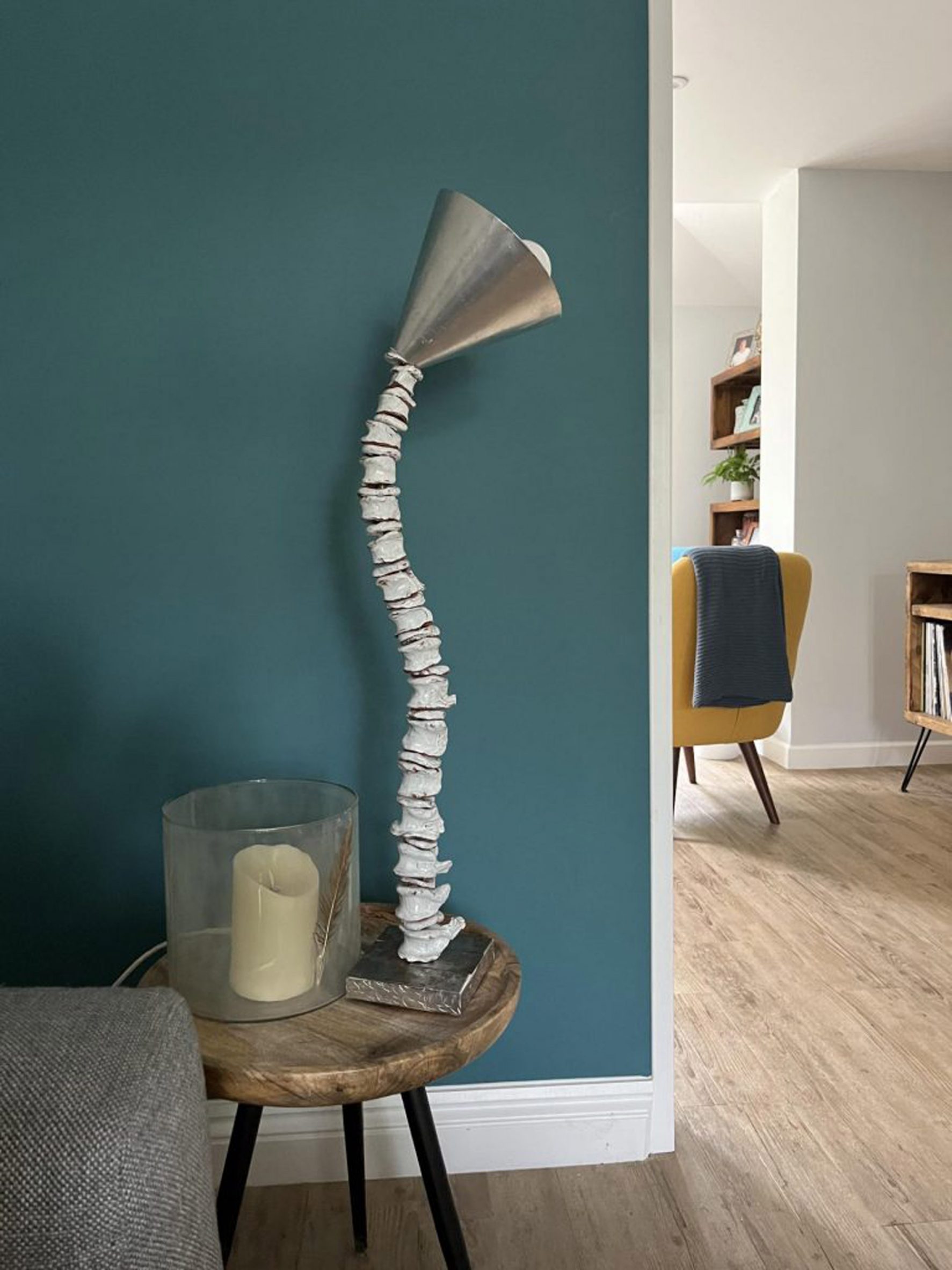 Home interior with spine-shaped lamp on the side table