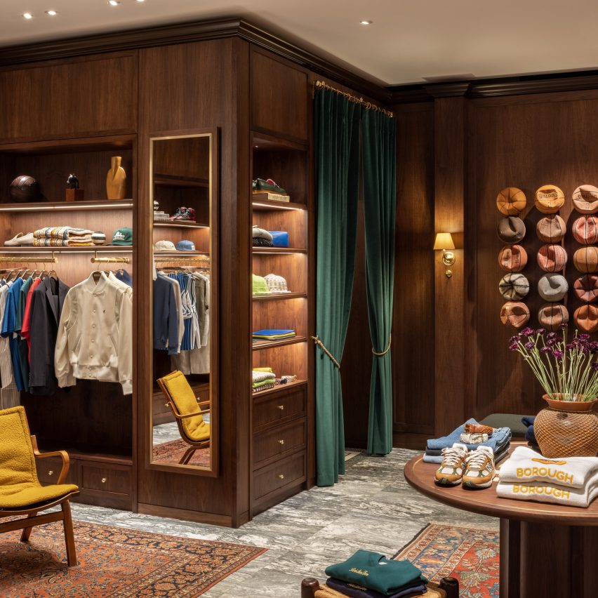 Walnut wood cabinetry in clothes shop interior by fashion brand Aimé Leon Dore