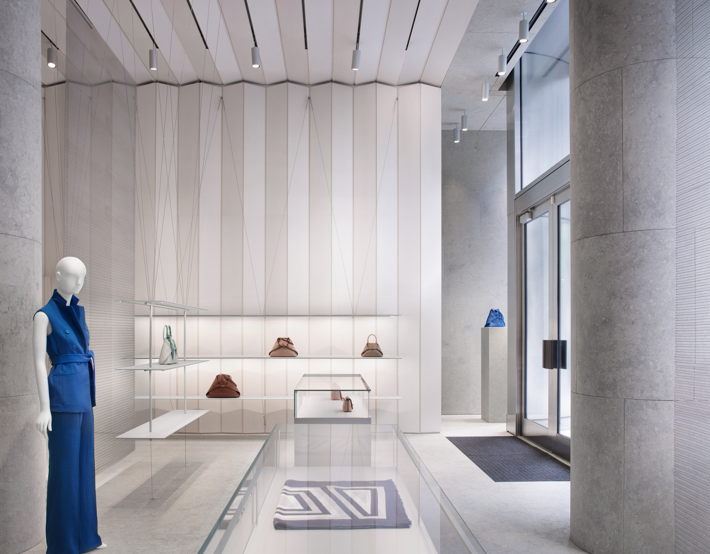 Boutique featuring pleated walls and floating shelves