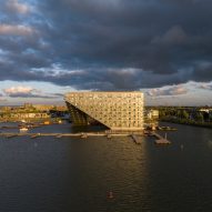 Sluishuis housing block by BIG and Barcode Architects cantilevered over IJ lake