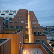 Sluishuis housing block by BIG and Barcode Architects cantilevered over IJ lake