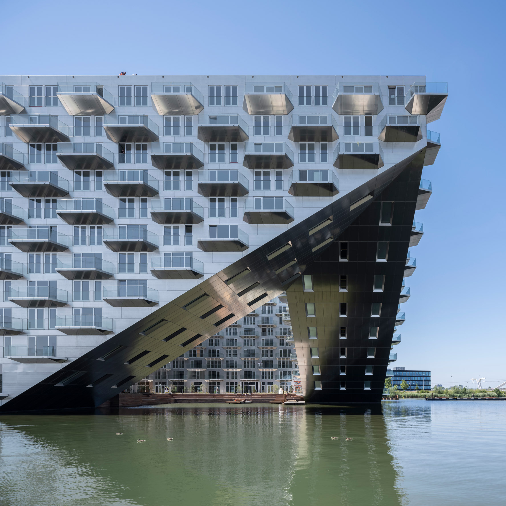 BIG and Barcode Architects cantilever housing block over IJmeer lake