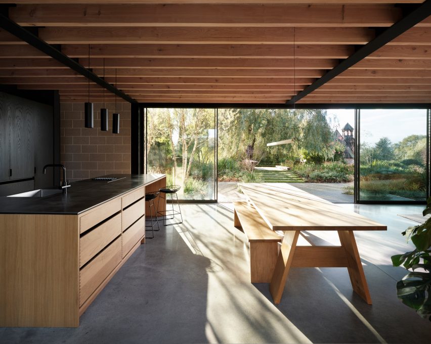 Light rays entering a kitchen with views of a large garden