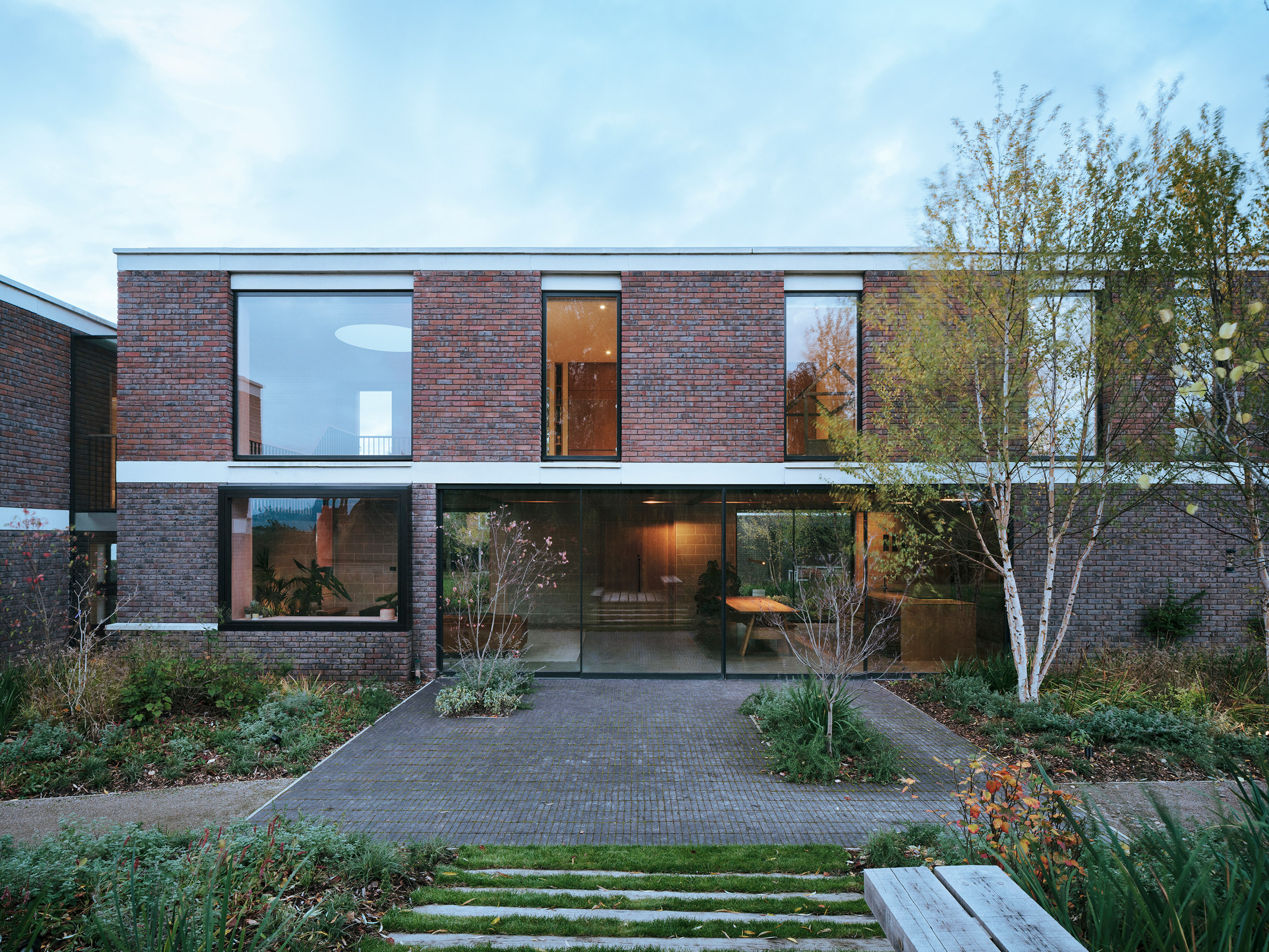 Large brick home with floor-to-ceiling windows in Derbyshire countryside